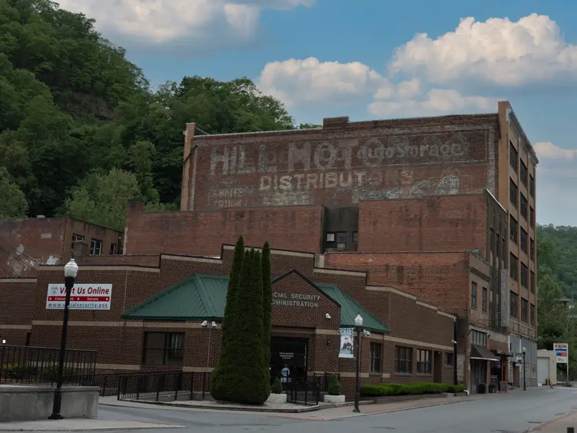The historic Buckingham Apartments building in Welch surrounded by the mountains of southern West Virginia.