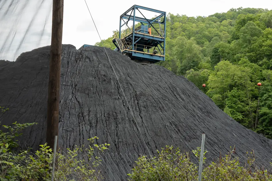 Large mound of coal rising beside the mountains of southern West Virginia.