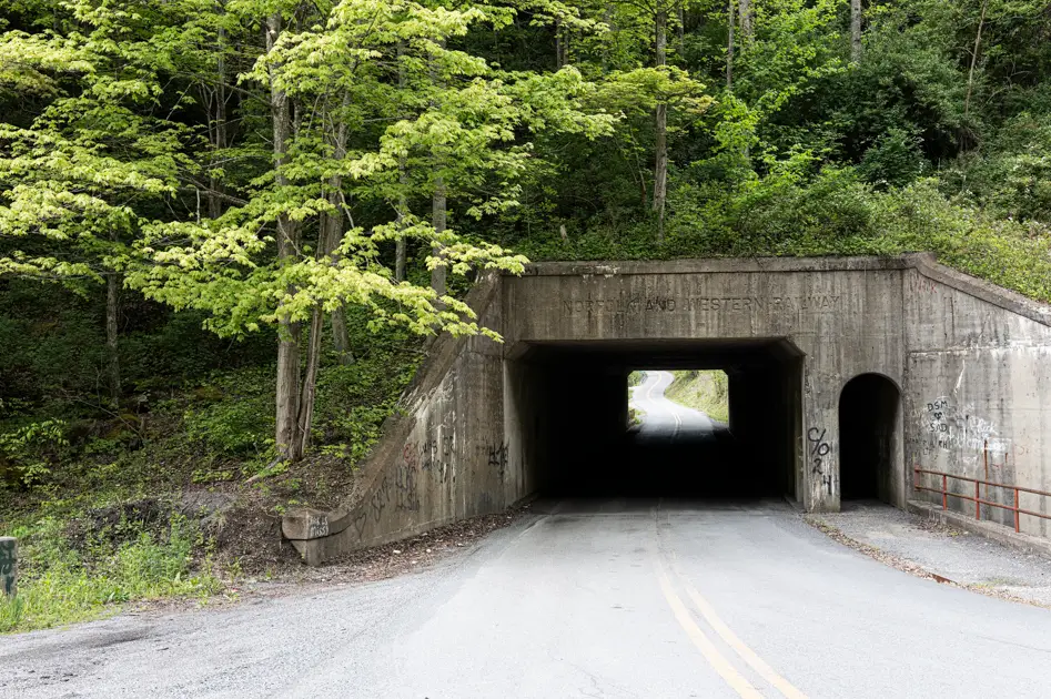 Mountain tunnel leading into Bluefield, West Virginia along a scenic Appalachian roadway.