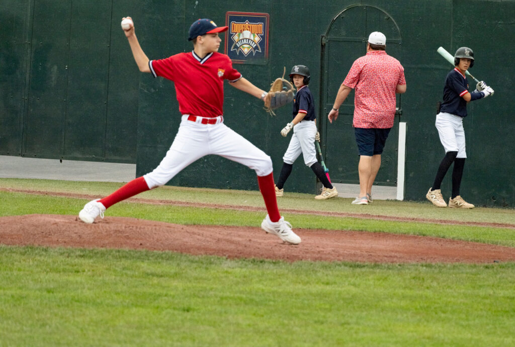 Youth baseball pitcher beginning his pitching delivery at Cooperstown Dreams Park.
