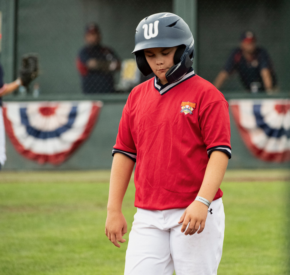 Youth baseball player showing disappointment after a play at Cooperstown Dreams Park.
